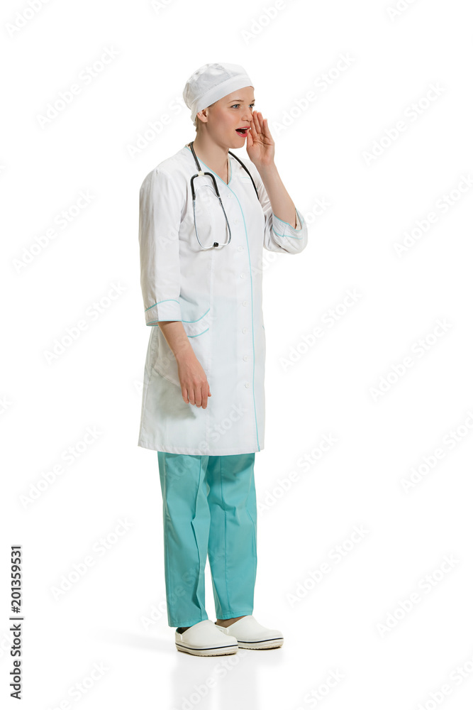 Beautiful young woman in white coat posing at studio. Full length studio shot isolated on white. Beautiful young woman in white coat posing at studio. Full length studio shot isolated on white.