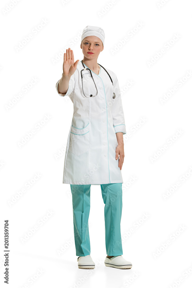 Beautiful young woman in white coat posing at studio. Full length studio shot isolated on white. Beautiful young woman in white coat posing at studio. Full length studio shot isolated on white.
