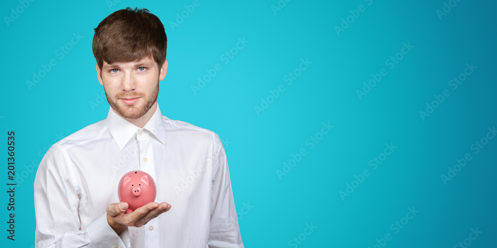 Young businessman with a piggy bank in his hands Young businessman with a piggy bank in his hands