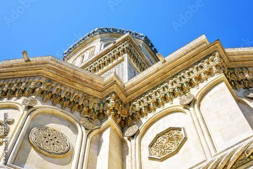 Daylight view from bottom to ornamented monastery facade photo