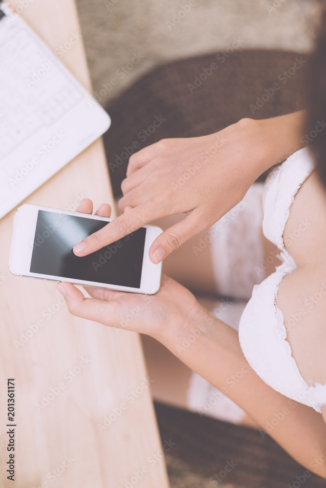 sexy Asian woman use of the smartphone sitting in bedroom sexy Asian woman use of the smartphone sitting in bedroom
