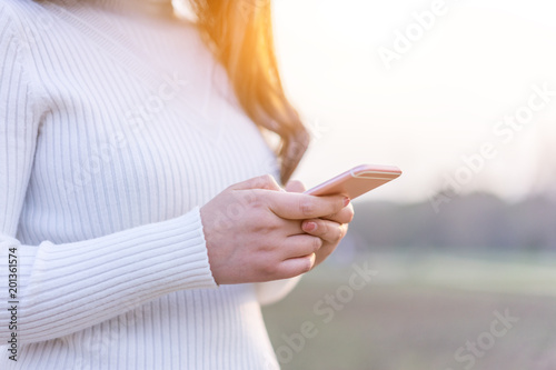 woman use smart phone during sunset