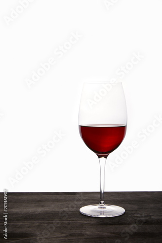 closeup view of red wine glass on wooden table