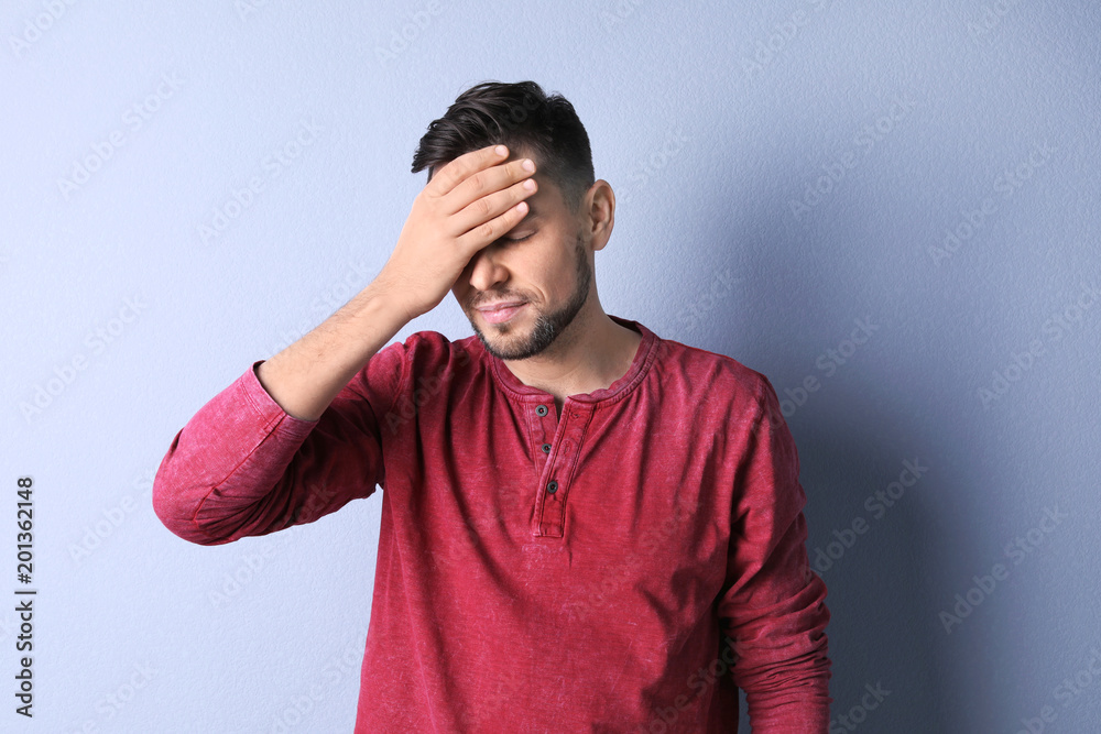 Man suffering from headache on color background Man suffering from headache on color background