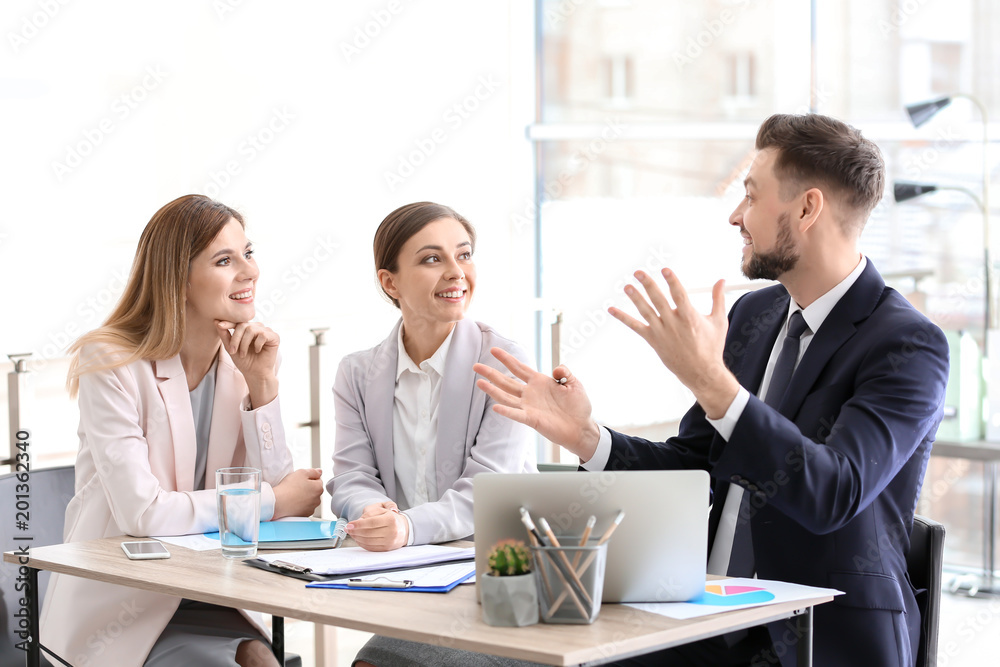 Young consultant working with clients in office Young consultant working with clients in office