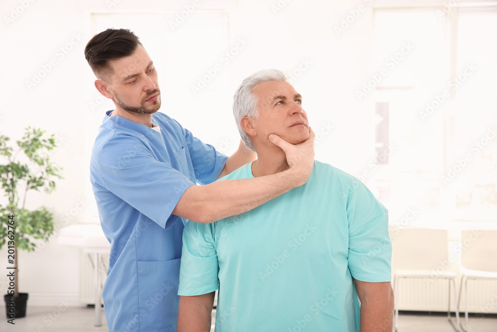 Young physiotherapist working with senior patient in clinic Young physiotherapist working with senior patient in clinic