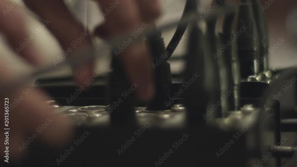Studio technician putting the cable in a switch. Cables switch board. Studio technician putting the cable in a switch. Cables switch board.