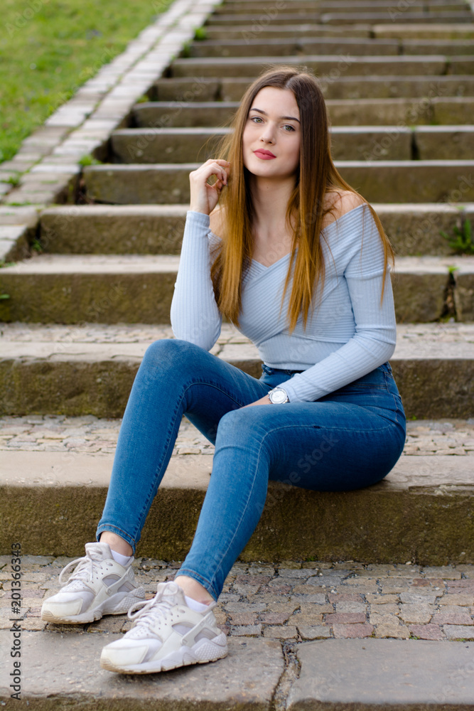 Young girl portrait sitting on stairs in park Young girl portrait sitting on stairs in park