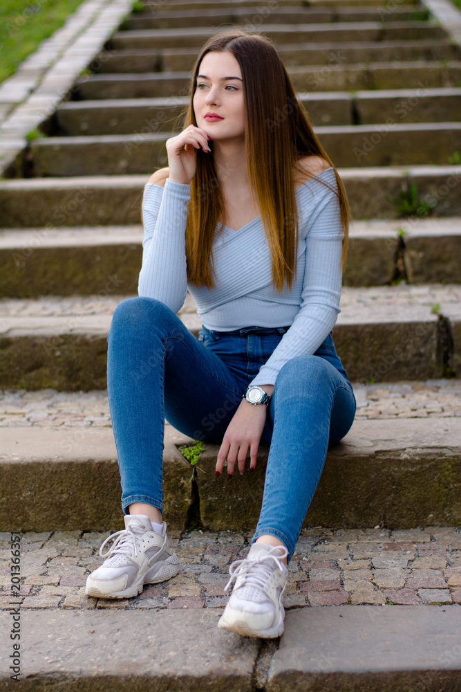 Young girl portrait sitting on stairs in park Young girl portrait sitting on stairs in park