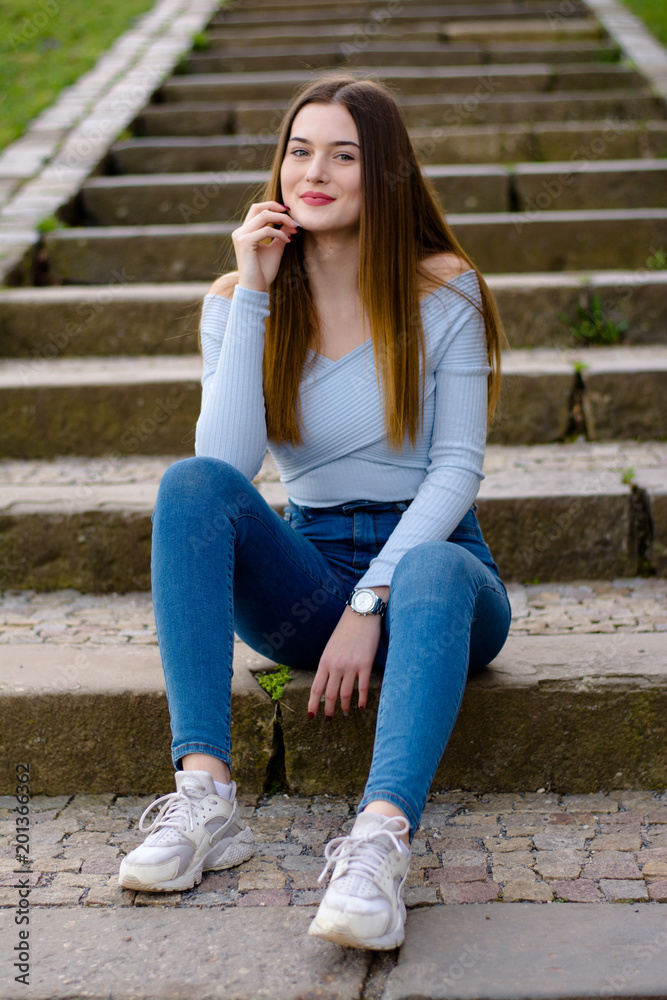 Young girl portrait sitting on stairs in park Young girl portrait sitting on stairs in park