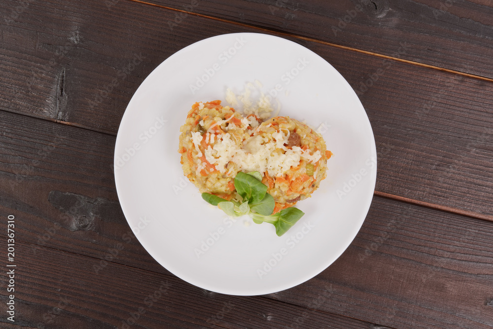 Risotto with carrot and cheese on table Risotto with carrot and cheese on table