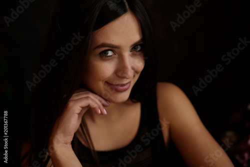 Beauty portrait of young adorable fresh looking brunette woman with long brown healthy curly hair.