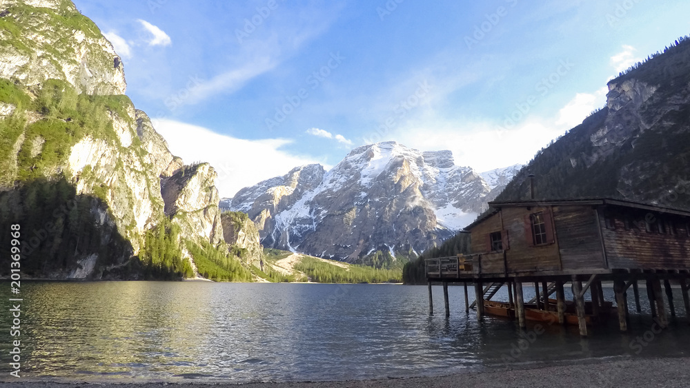 Fisherman house standing near lake in South Tyrol, amazing view of mountains