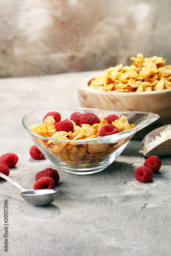 Bowl of Cornflakes and Raspberries for a healthy breakfast concept