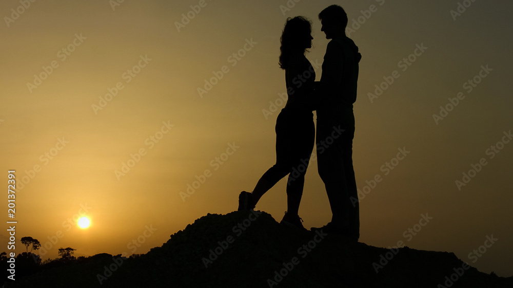 Young man and woman in love hugging passionately, kissing, romantic feelings