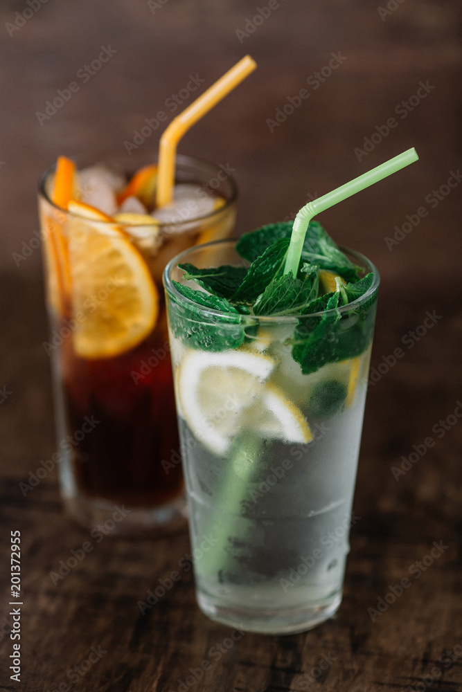 Two glasses of lemonade on a wooden background Two glasses of lemonade on a wooden background
