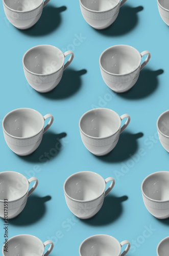 Pattern. Cup concept. Group of white cups on blue background. Creative style.