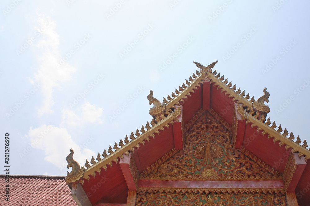 The roof of aranyaram temple on blue sky background ,Lamphun,Thailand The roof of aranyaram temple on blue sky background ,Lamphun,Thailand