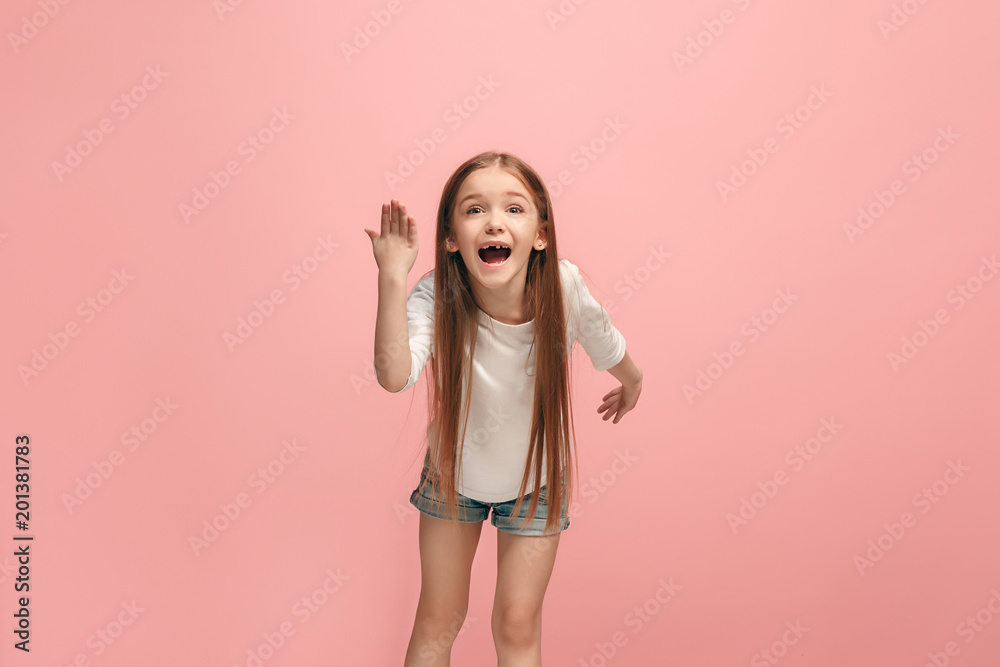 Beautiful female half-length portrait on pink studio backgroud. The young emotional teen girl
