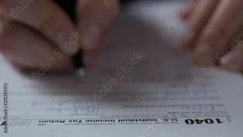 Man filling US tax form. tax form us business income office hand fill concept. Closeup.  Man Is Checking The Box Of Filing Status In The US Individual Income.  Tax Return Form 1040