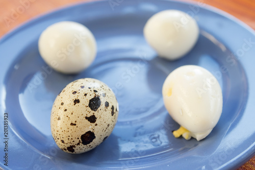 hard boiled quail eggs put on a blue dish