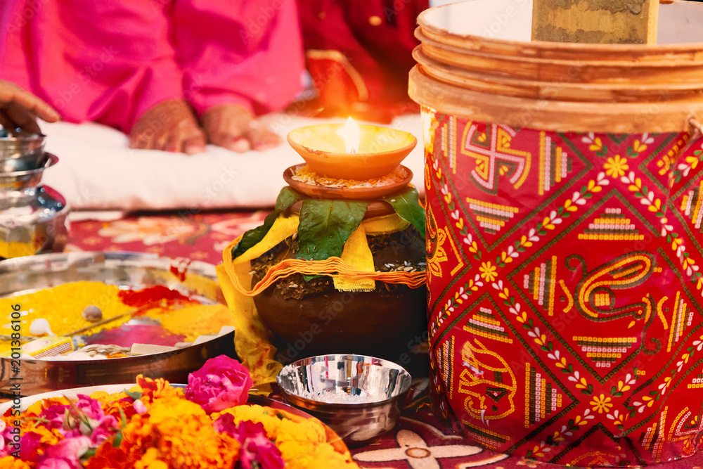 Indian Hindu wedding puja background with holy oil lamp and pitcher