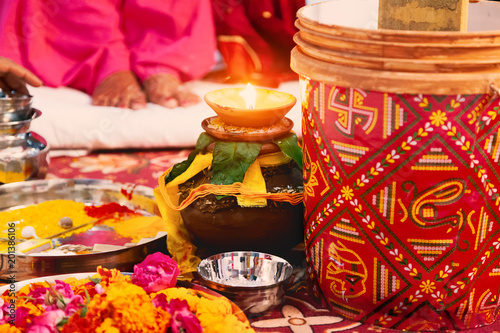 Indian Hindu wedding puja background with holy oil lamp and pitcher.