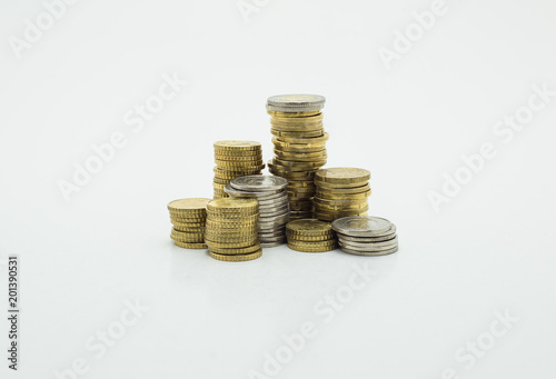 Stack of gold and silver coins isolated on white background with clipping path. Growing and saving money concept 