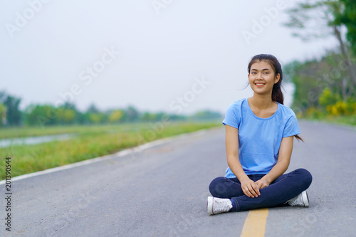 Woman sitting on the road in the park © Naypong Studio