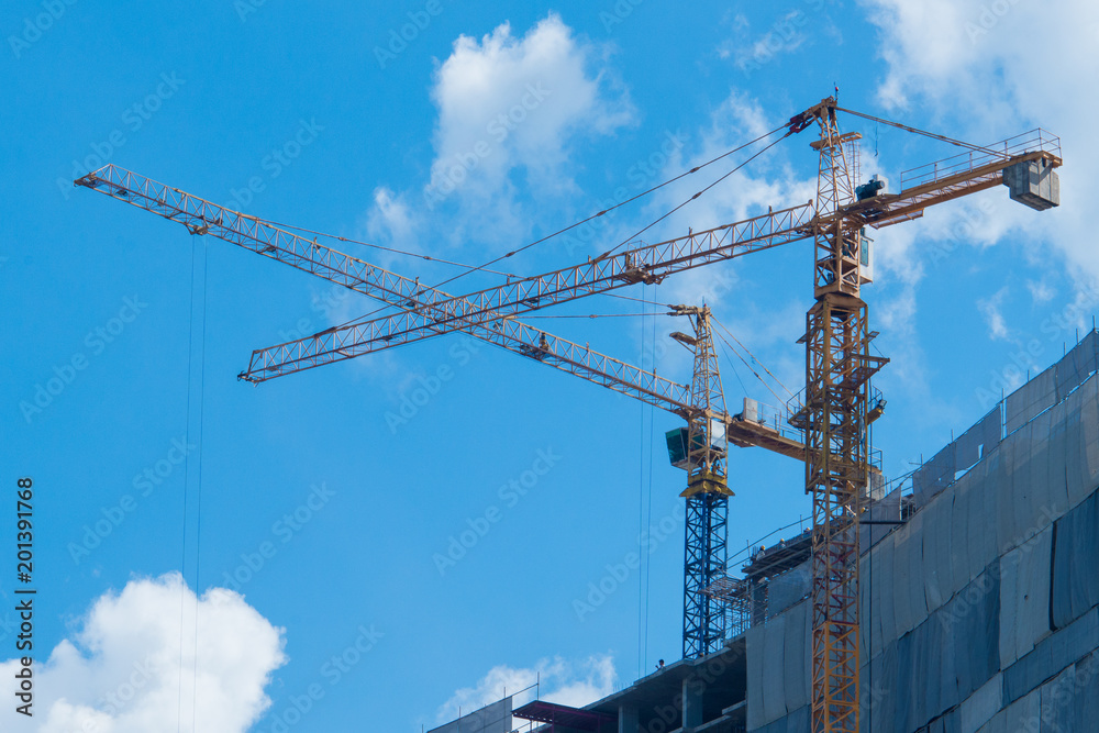 high crane working with blue sky background for construvtion and building condo