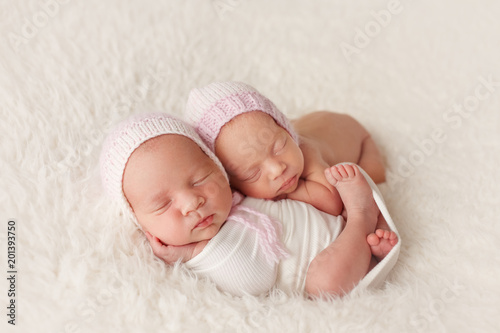Newborn twin sisters sleep