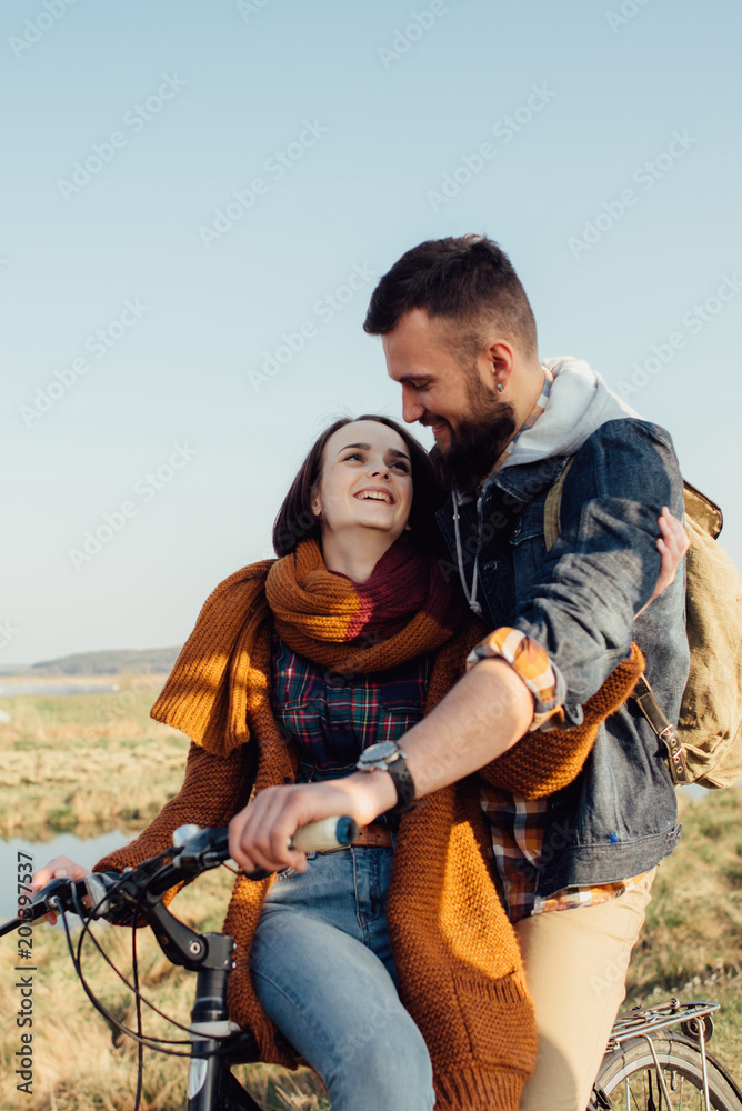 couple in love on a bike on nature in autumn