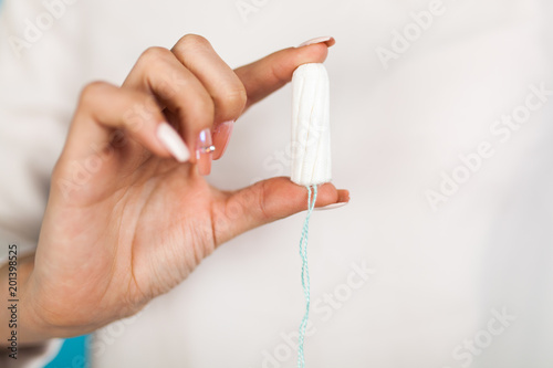 Woman holding a tampon
