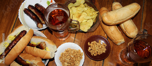 Photos fried sausages, beer and peanuts on a wooden background