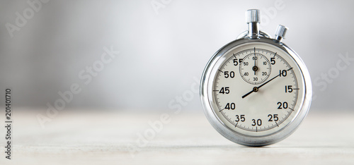 Analog stopwatch on grey background photo