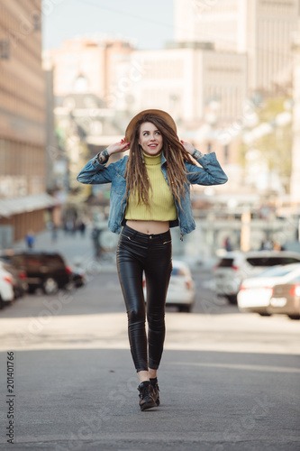 Street style, fashionable woman walking in city on road