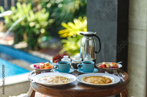 Balinesse breakfast on wooden table photo