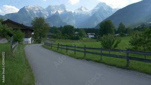 Slow traverse of a rural road in Au near Lofer, Austria, with the Loferer (Lofer) Mountains in the background.