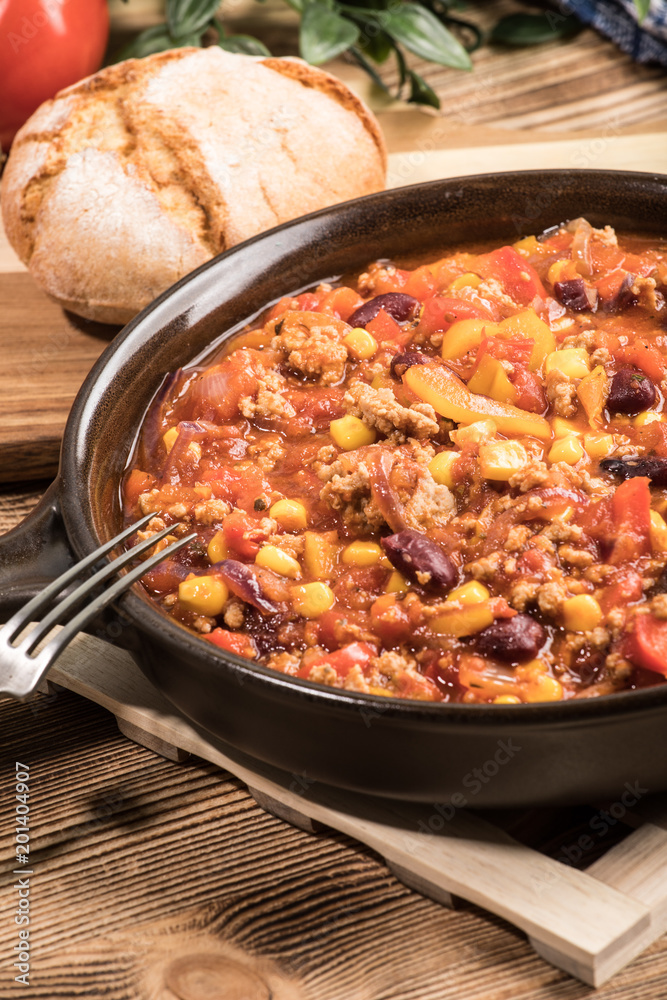 Chili con carne in a clay pan. Chili con carne in a clay pan.