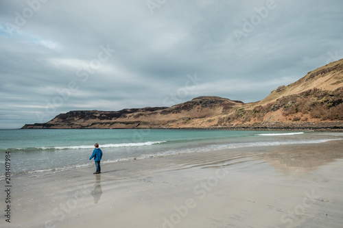 Child on a deserted beach in Scotland