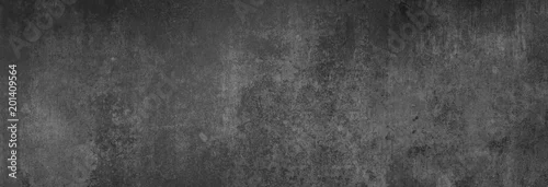 Panel kuchenny z motywem Textur einer fast schwarzen Betonwand in XXL-Größe als Hintergrund, auf die leichtes Licht fällt