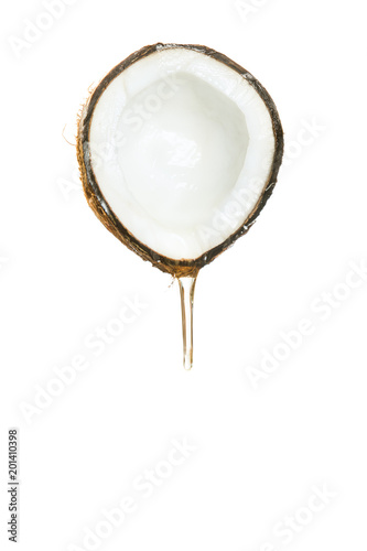 Half of a coconut with a flowing transparent liquid on a white background