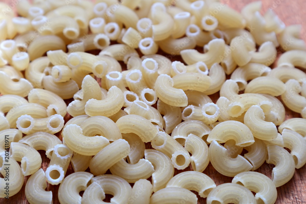 Raw pasta. Macro. Spilled on the table pasta. Background Raw pasta. Macro. Spilled on the table pasta. Background