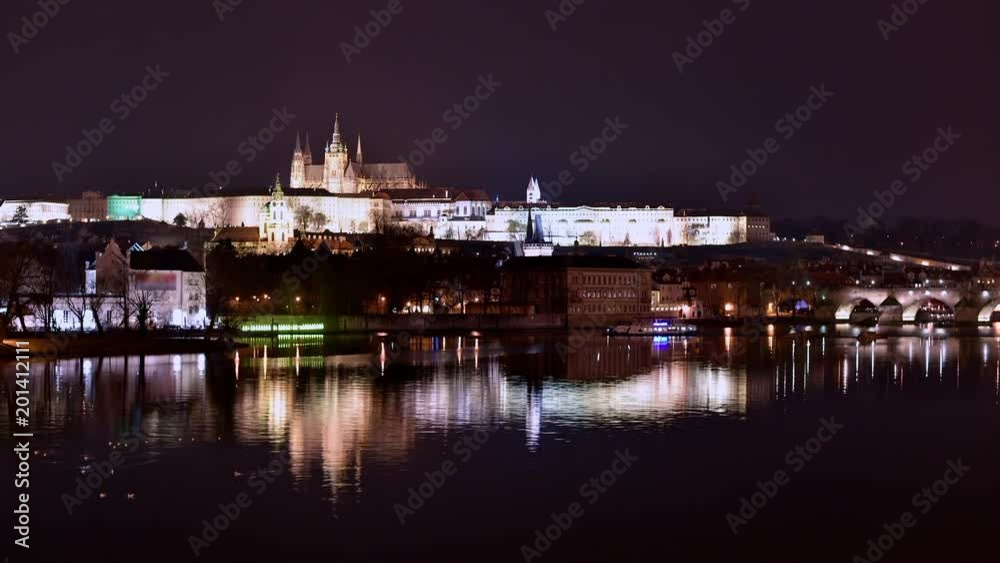 Timelapse of Vltava river at charles bridge and prague castle at night with reflections, czech republic Timelapse of Vltava river at charles bridge and prague castle at night with reflections, czech republic