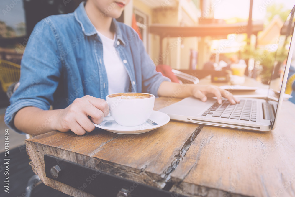 Beautiful hipster woman using laptop at cafe Beautiful hipster woman using laptop at cafe