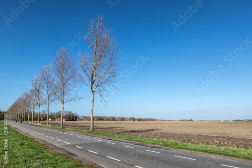 Dutch farmland in spring with bare fields waiting for growth of cereals photo