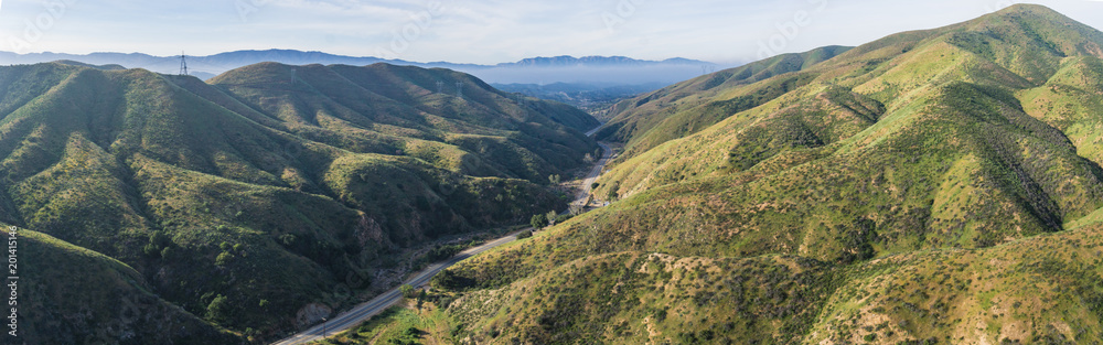 Strand of gray asphalt leads through the quiet narrow valleys of southern California's Canyon Country.