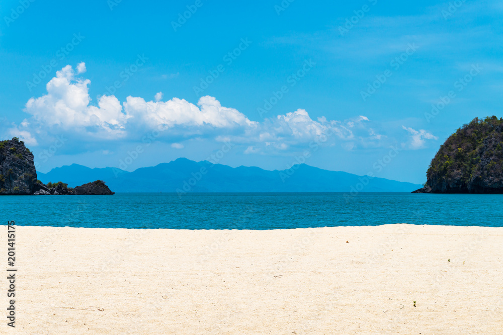 Tropical beach with white sand and island in the sea background. Vacation concept.