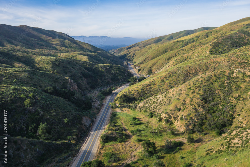 Road leads along the bottom of a canyon in southern California's Los Angeles County. Road leads along the bottom of a canyon in southern California's Los Angeles County.