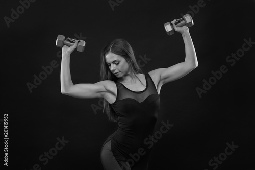 fitness woman in doing exercises with dumbells.